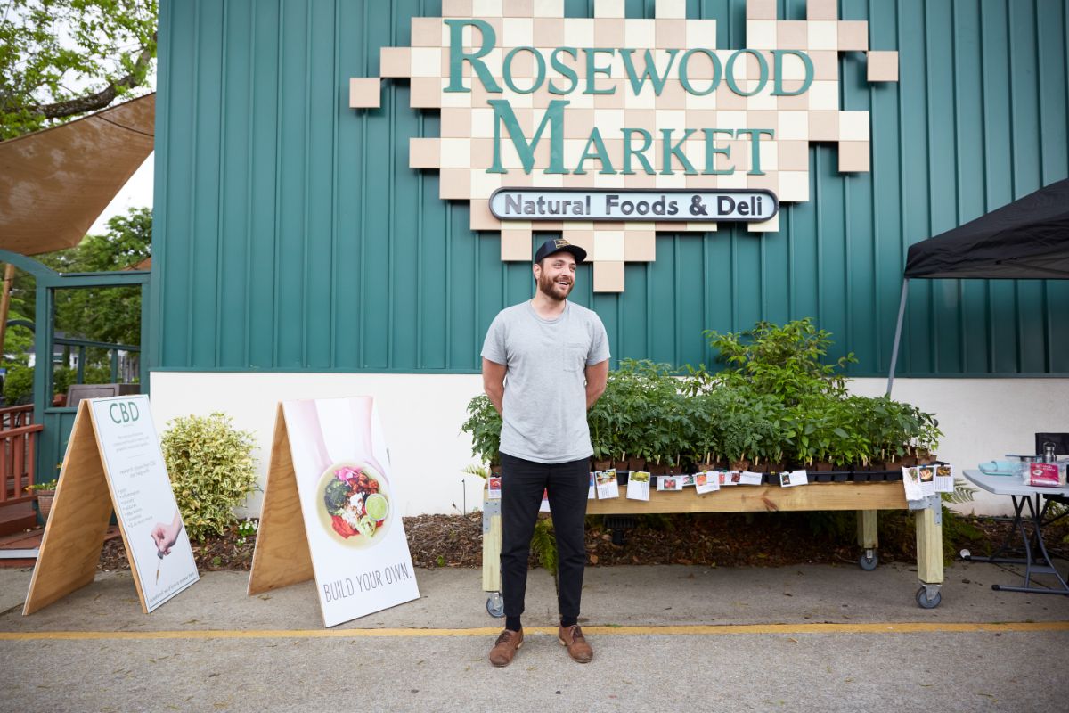 rosewood market owner standing in front of store
