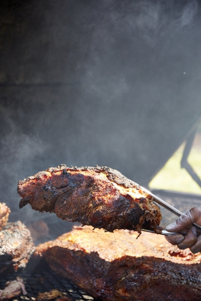 Brisket with smoke in the background