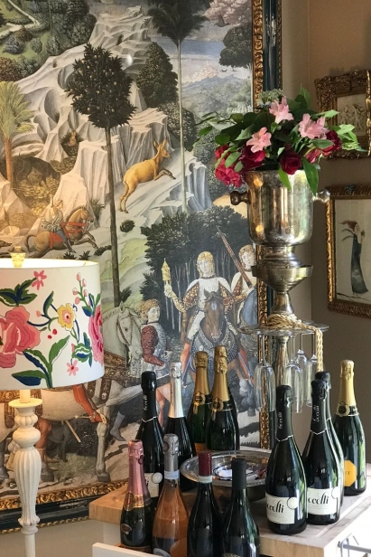 champagne bottles in front of intricate painting