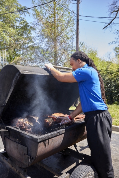 Man cooks meat in a smoker