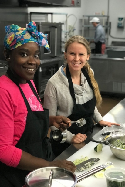 volunteers smiling while cooking