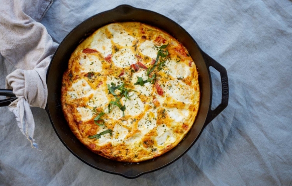 A skillet with caprese frittata